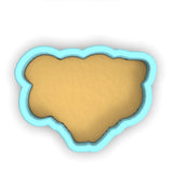 a cookie cutter with a cookie in the shape of a bear