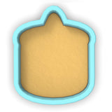 a cookie cutter with a cookie in the shape of a house