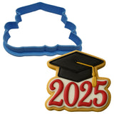 a cookie shaped like a graduation cap and a cookie cutter
