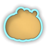 a cookie shaped like a bear with a blue outline