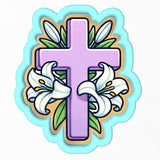 a cross with lilies and leaves on it