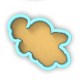a cookie cutter with a cookie shaped like a teddy bear