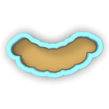 a cookie cutter shaped like a sausage on a white background