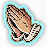 a sticker of a praying hands on a white background