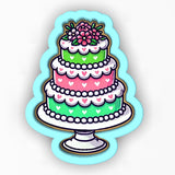 a three layer cake with hearts and a flower on top