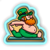 a st patrick's day sticker of a man on a laptop