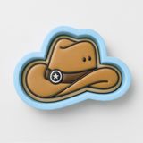 A cowboy hat cookie cutter in the shape of a cloud, with a star symbol on the front.