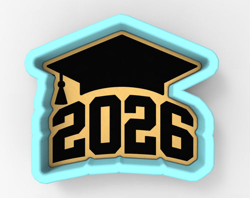 A graduation cap-shaped cookie cutter with the number "2026" printed on it.