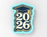 A graduation cap and the number "20 26" in a cookie cutter shape, representing the year of graduation.