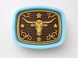 a decorative blue tray with a gold bull's head design on it.