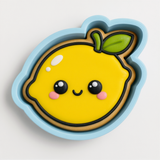 A cookie cutter in the shape of a smiling lemon with a leaf on top.