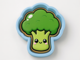 A cartoon-style broccoli with a smiling face, set against a plain white background.