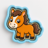 A cartoon horse cookie cutter in a blue shape.