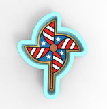 a red, white and blue pinwheel on a stick