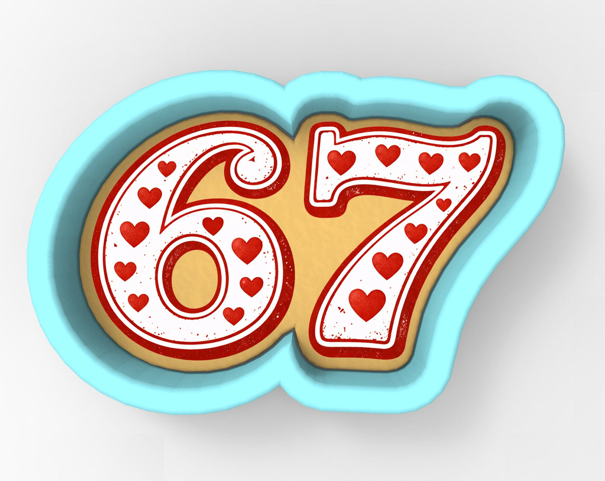A cookie cutter shaped like the number 67, with hearts decorating the number.