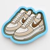 A pair of white and brown Nike Air Force 1 sneakers with the Nike Air logo visible.