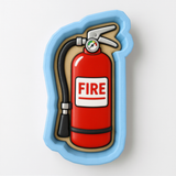 A fire extinguisher in a cookie cutter shape, with the word "FIRE" written on it.