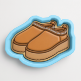 A pair of brown platform sandals with a distinctive lace-up design.