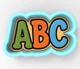 A colorful, cloud-shaped cookie cutter with the letters "ABC" in a playful font.