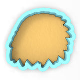 a cookie cutter with a cookie in the shape of a hedge