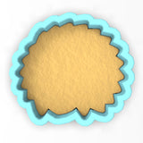 a cookie cutter with a cookie in the shape of a circle