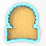 a cookie cutter with a piece of bread cut out of it