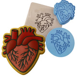 a cookie cutter with a heart and a stencil
