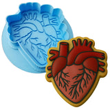 two heart shaped cookie molds sitting next to each other