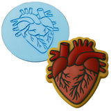 a cookie with a heart on it and a cookie with a stencil of