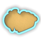 a cookie shaped like a bear with a blue frame