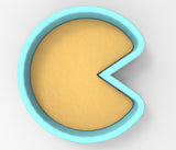 A blue bowl with a slice cut out of it, containing a yellow substance.