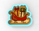 A cookie cutter-shaped illustration depicting a red sleigh carrying three wrapped gifts with bows.