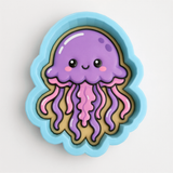 A blue cookie cutter shaped like a purple jellyfish with pink tentacles.