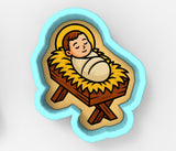 A cartoon image of a baby in a manger, with a halo around the baby's head.