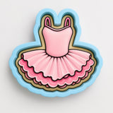 A pink tutu-style dress with a ruffled skirt and a ruffled bodice, depicted in a cookie cutter shape.