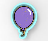 a purple balloon with gold sprinkles in a blue bowl