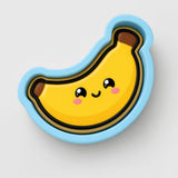 A cartoon banana with a smiling face and a blue outline.