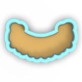 a cookie cutter with a cookie shaped like a scallop