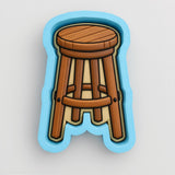 A wooden stool with a curved backrest and seat, depicted in a blue mold or cutout shape.