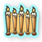 a group of candles that are on a sticker