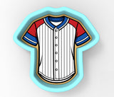 A cookie cutter in the shape of a baseball jersey, with red, white, and blue stripes.