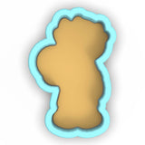 a cookie cutter with a cookie shaped like a bear