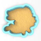 a cookie cutter with a cookie in the shape of a fish