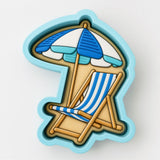A blue and white striped beach chair and umbrella are depicted in the image.