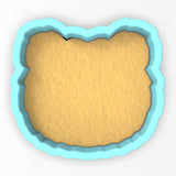 a cookie cutter with a cookie in the shape of a bear