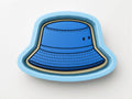 A blue bucket hat-shaped cookie cutter is shown against a white background.