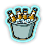 a bucket of beer with ice cubes in it