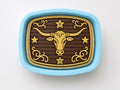 a decorative blue tray with a gold bull's head design on it.