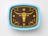a decorative blue tray with a gold bull's head design on it.