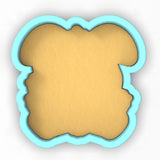 a cookie shaped like a face on a white background